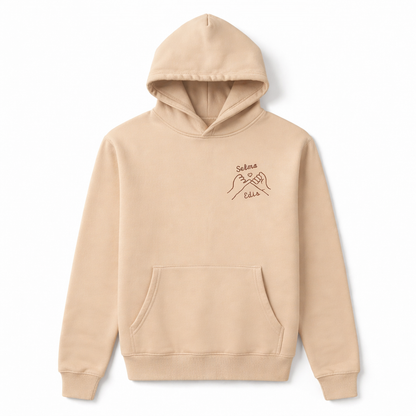 Beige personalized hoodie with pinky promise embroidery. Professionally stitched for long-lasting quality.