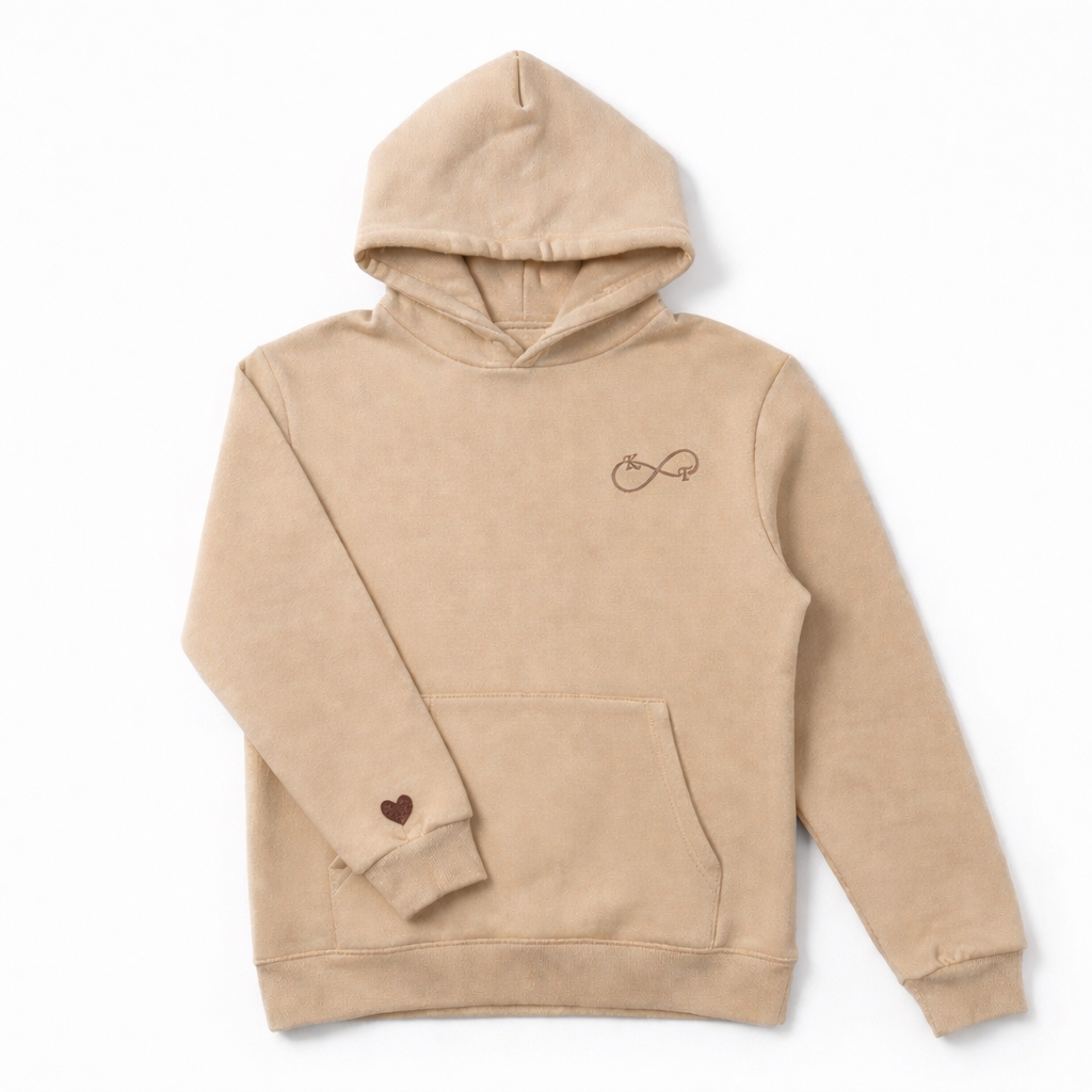 Beige unisex hoodie featuring brown thread custom infinity embroidery with initials and sleeve heart, embroidered by Sharp Stitch in Illinois, shipping across all U.S. states including California, Texas, New York, Florida, and nationwide.