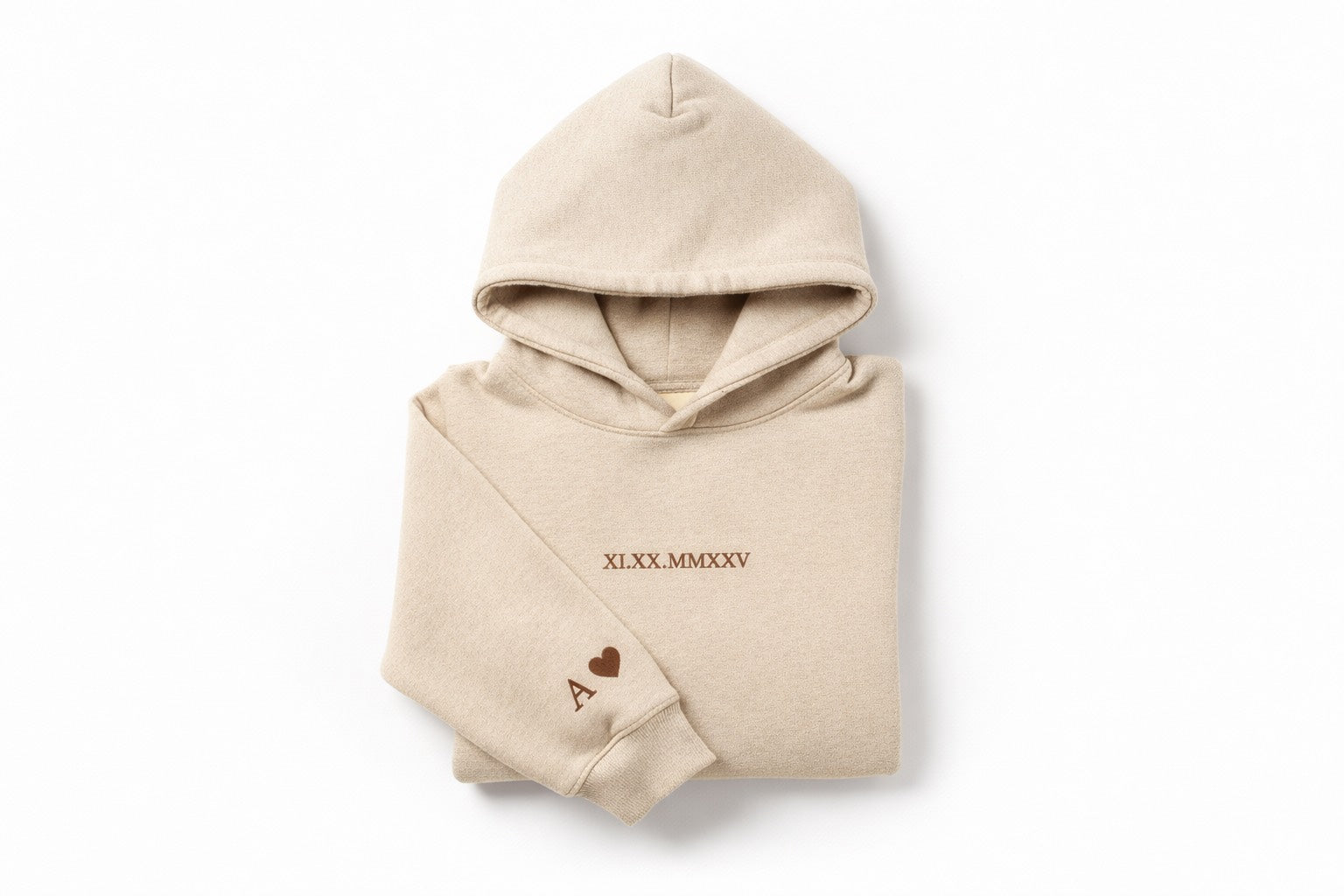 Custom couples embroidered beige hoodie with brown thread by Sharp Stitch, featuring personalized roman numerals on the chest and initials with a heart on the sleeve. Professional custom embroidery and DTF printing for hoodies and crewneck sweatshirts, casual wear, workwear, and uniforms, with nationwide shipping across the USA.