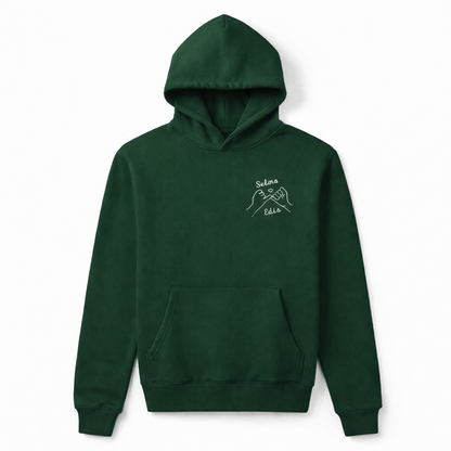 Green custom embroidered sweatshirt with two personalized names. Sharp Stitch custom embroidery and DTF printing services.