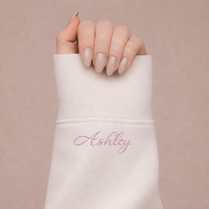 Hoodie - color: white, Text: Ashley in pink – Custom embroidery by Sharp Stitch, Niles IL, Chicago IL, Shipping nationwide (AL, AK, AZ, AR, CA, CO, CT, DE, FL, GA, HI, ID, IL, IN, IA, KS, KY, LA, ME, MD, MA, MI, MN, MS, MO, MT, NE, NV, NH, NJ, NM, NY, NC, ND, OH, OK, OR, PA, RI, SC, SD, TN, TX, UT, VT, VA, WA, WV, WI, WY)