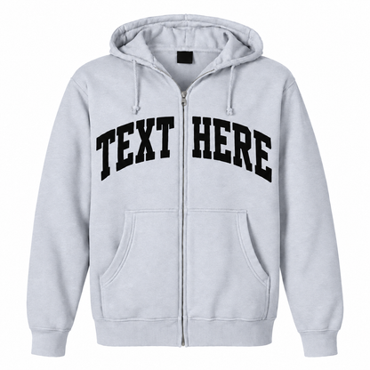 A light gray zip-up hoodie with 'TEXT HERE' printed in black arched block letters across the chest, shown on a plain white background.

