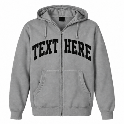 A light gray zip-up hoodie with 'TEXT HERE' printed in black arched varsity letters across the chest, shown on a plain white background.

