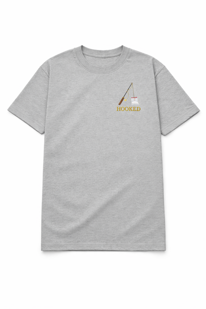 Grey t shirt with a small chest DTF printed fishing rod design and the word Hooked in a minimalist style