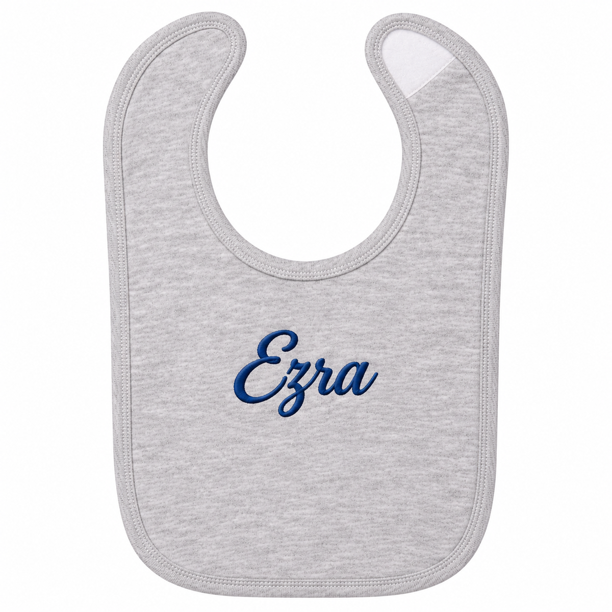 A light heather gray baby bib with the name 'Ezra' embroidered in dark blue cursive script in the center, shown on a plain white background.

