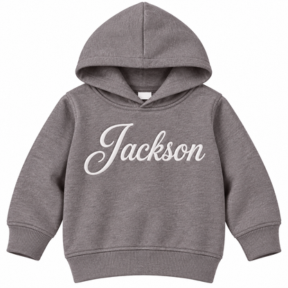 A toddler-sized heather gray pullover hoodie with the name 'Jackson' printed across the chest in a white cursive script, shown against a plain white background.

