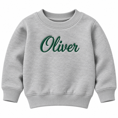 A light heather gray crewneck sweatshirt with the name 'Oliver' embroidered in dark green cursive script across the chest, shown on a plain white background.

