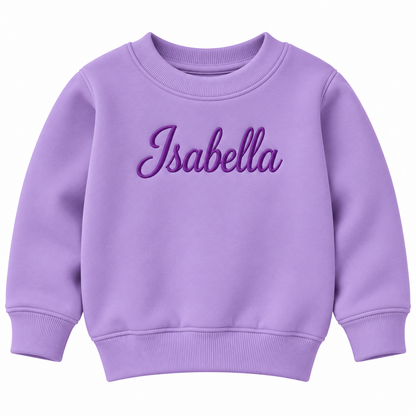 A lavender purple crewneck sweatshirt with the name 'Isabella' embroidered in a darker purple cursive font across the chest, displayed on a solid white background.

