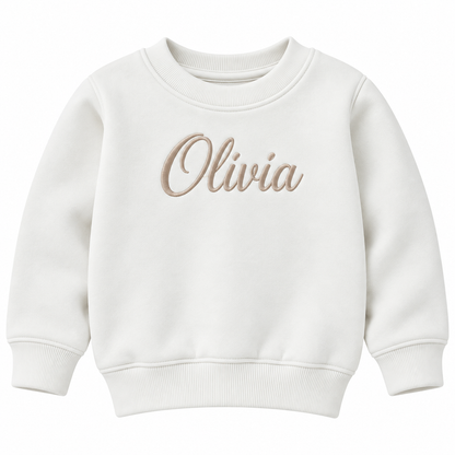 An off-white crewneck sweatshirt with the name 'Olivia' embroidered in a beige cursive font across the chest, displayed on a clean white background.

