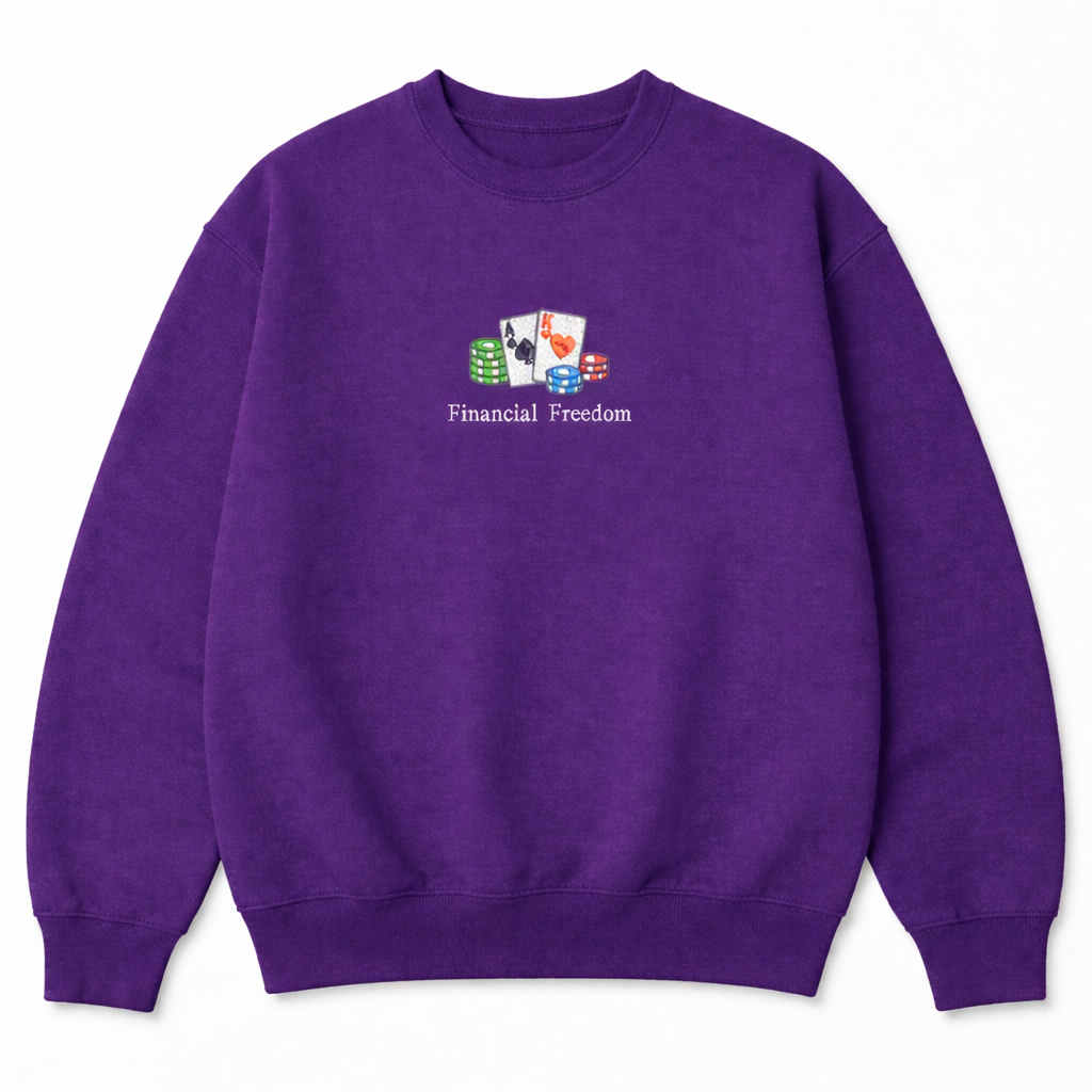 Purple crewneck sweatshirt with a small embroidered gambling design including playing cards, poker chips, and Financial Freedom text